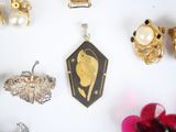 many different types of jewelry displayed on a white surface