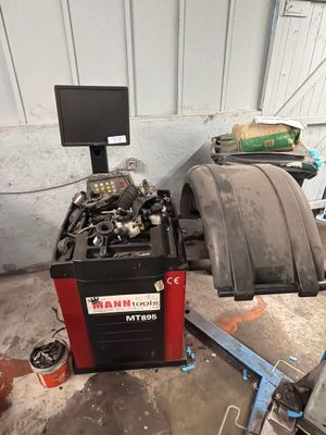 a tire being worked on by a mechanic in a garage