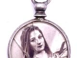a picture of a woman holding a bird in her hand
