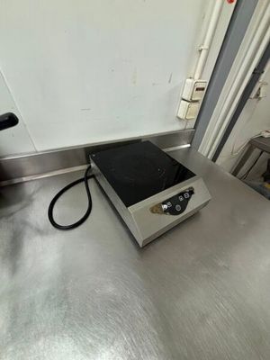 a silver counter top with a black burner on it