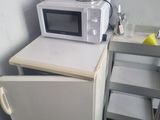 un micro-ondes et un petit réfrigérateur dans une petite pièce