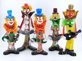 cinq figurines de clowns avec des guitares et des chapeaux