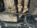 a close up view of a car ' s engine and exhaust pipes