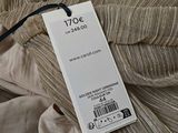 a price tag on a dress on a bed