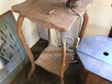 a small table with a lamp on top of it next to a chair