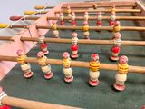 a foosball table that has a bunch of wooden toys on it