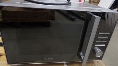 a microwave that is sitting on a table in a room