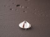 a close up photo of a tear shaped diamond on a table