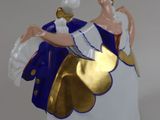 a figurine of a man and a woman sitting on a cloud