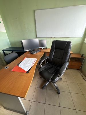 a desk with a chair and a computer on it