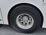 a close up of a white bus parked on the side of the road
