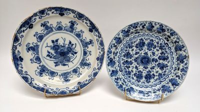 pair of blue and white plates with flowers on them on a white surface