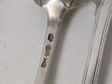 a spoon, fork, and spoon rest on a table