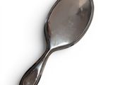 a silver spoon with a silver handle on a white surface