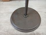 an image of a metal umbrella stand on the floor