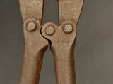 a close up of a pair of pliers on a table