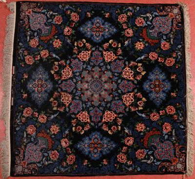 an image of a blue and red rug on a pink wall