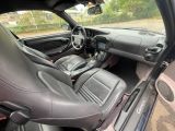 the interior of a car with leather seats and a steering wheel