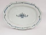 a blue and white plate with a flower design on it
