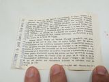 a person holding a piece of paper in their hand