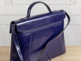 a blue purse sitting on top of a wooden table