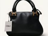 chloe ' s black leather handbag with gold handles and a tag