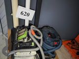 an image of a room with a vacuum and a bag on the floor