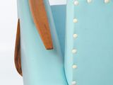 a blue chair with a wooden arm rest on a white background