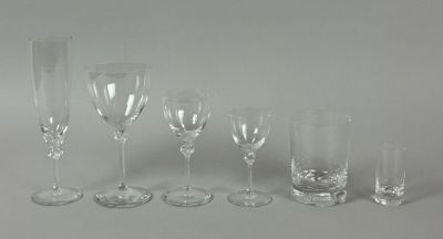 a group of wine glasses and a vase on a table