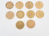 six different types of coins on a white surface