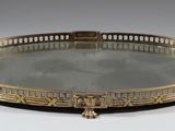 an antique brass tray with a mirror on top of it