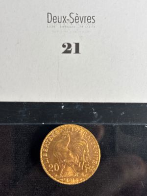 a close up of a gold coin on a black surface
