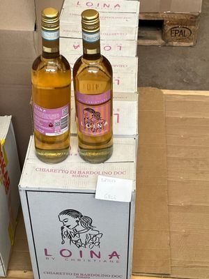two bottles of wine sitting on top of a cardboard box