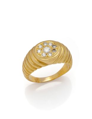 a yellow gold ring with diamonds on a white background