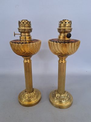 pair of antique brass candlesticks on pedestals with black marble top
