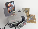 a nintendo game system sitting on top of a table next to a box of nintendo games