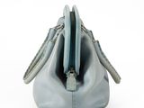 a blue purse that is sitting on a white surface