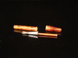 two pens that are sitting on a black surface