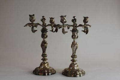 pair of antique brass candlesticks with birds and flowers