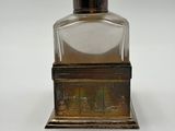 an image of a bottle of perfume sitting on top of a table
