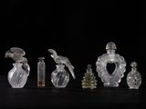 several glass bottles with birds on them sitting on a table