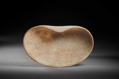 an old stone heart shaped object sitting on top of a table