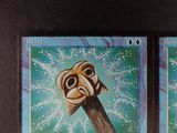 two cards on the table that have a picture of a man on a stick