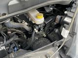 the engine compartment of a car with its hood open and the hood open