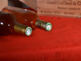 three bottles of wine sitting on a red table cloth