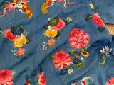 an image of a blue dress with pink and yellow flowers on it