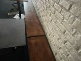 a table that is sitting in front of a brick wall
