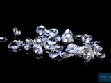 a close up of a bunch of diamonds on a black surface