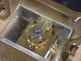 a gold clock that is sitting on a table