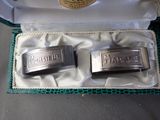 pair of silver cuff rings in a box with a label on it
